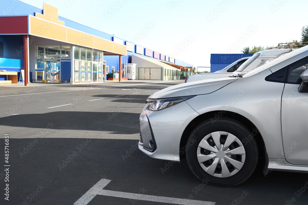 Cars parked in parking lot near supermarket