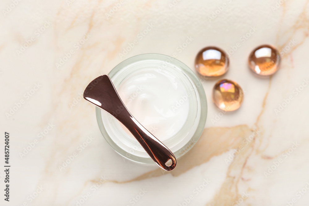 Jar with natural cosmetic cream on light background