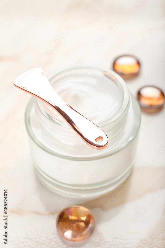 Jar with natural cosmetic cream on light background, closeup