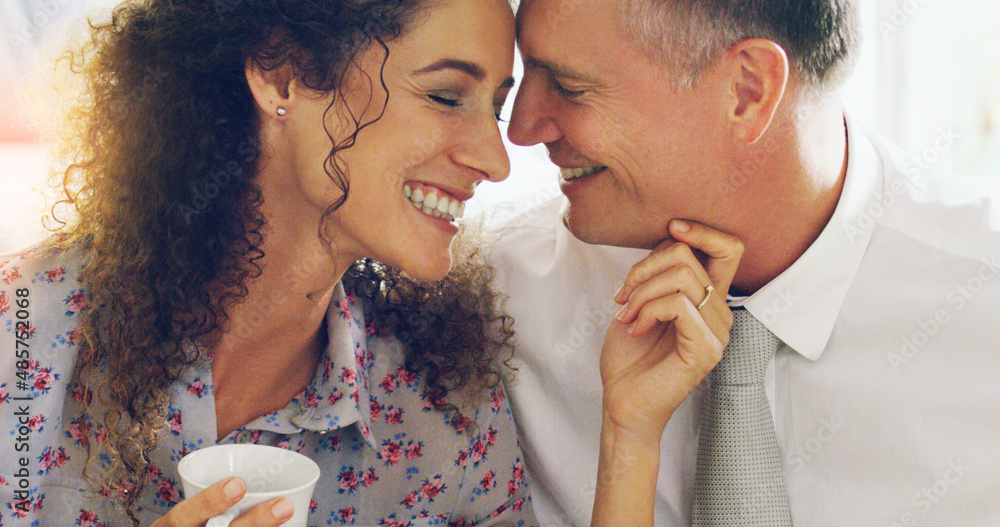 Tea with you makes mornings the sweetest. Shot of an affectionate middle aged couple having coffee t