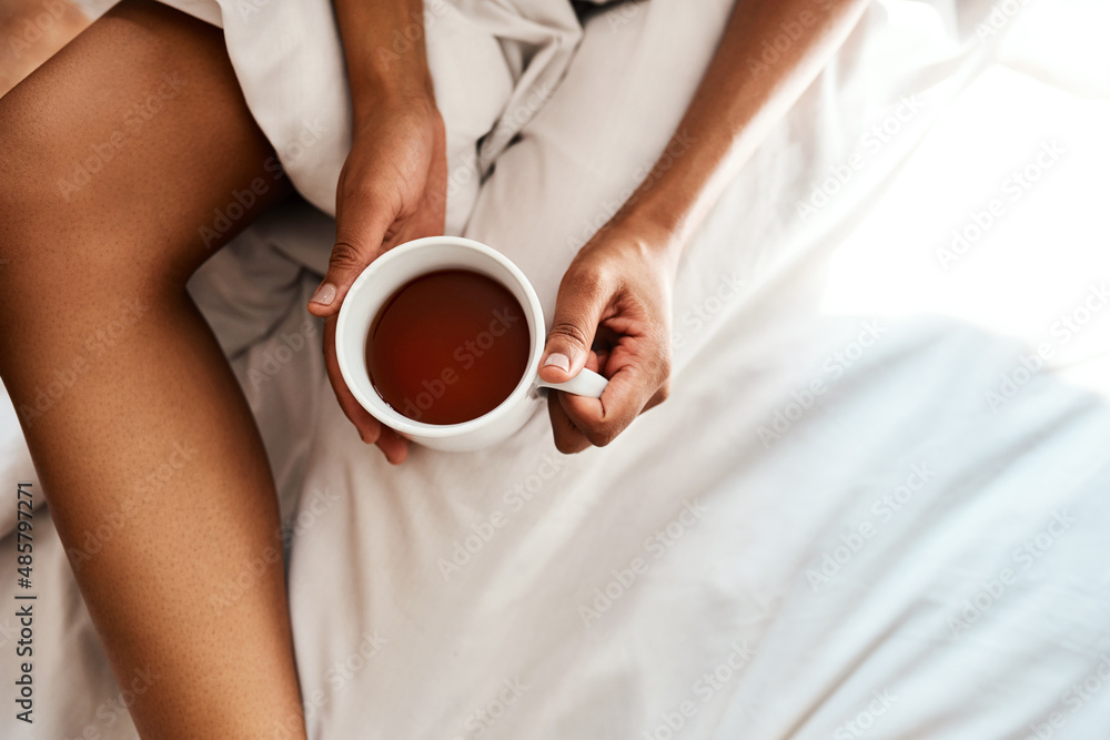 My morning tea is very important. Cropped shot of an unrecognizable woman holding a cup of team whil