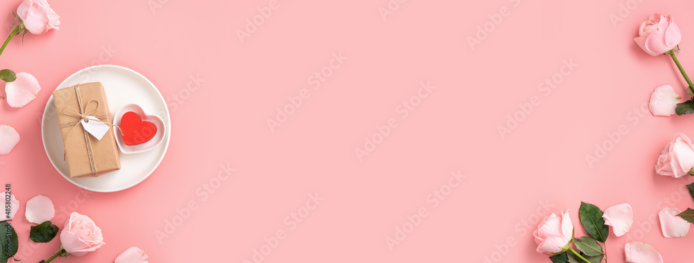 Valentines Day gift and meal design concept background with pink rose flower on pink background.