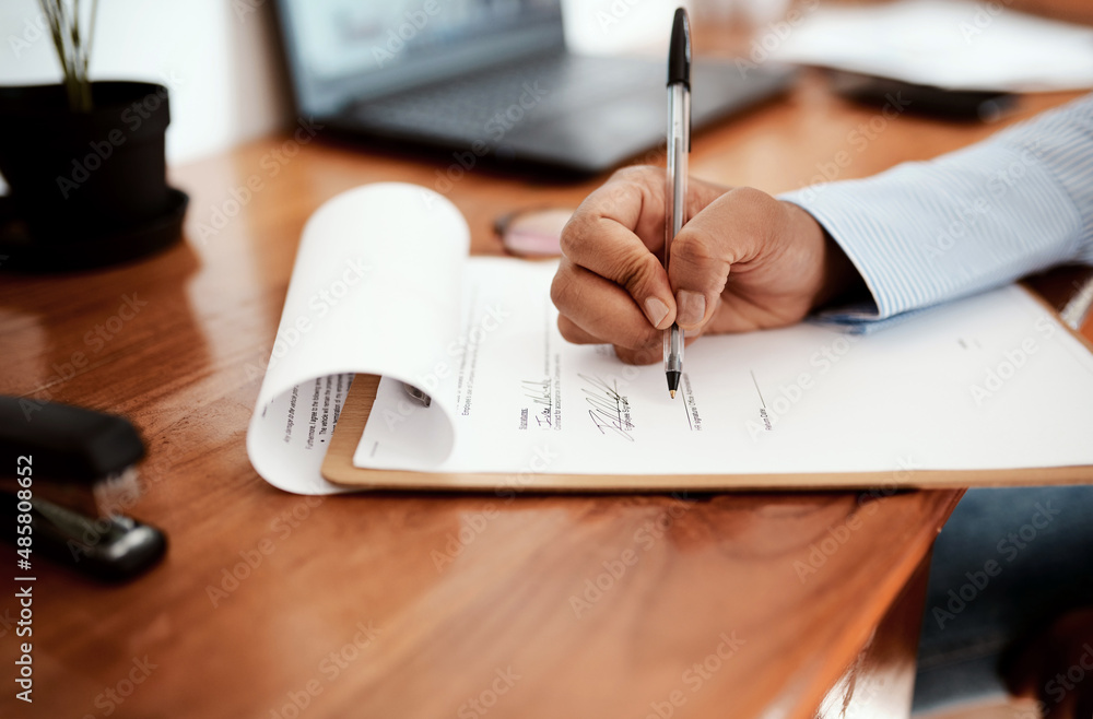 The biggest business deal to date. Cropped shot of a businesswoman filling out paperwork at her desk