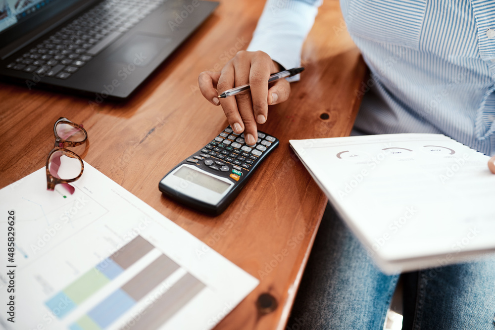 Business is a numbers game. Cropped shot of a businesswoman using a calculator while going over fina