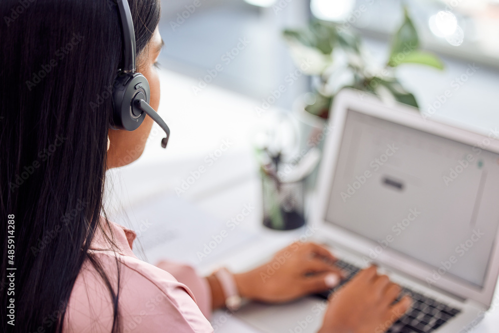 If theres a problem, well a.find a the solution. Shot of a businesswoman wearing a headset while wor