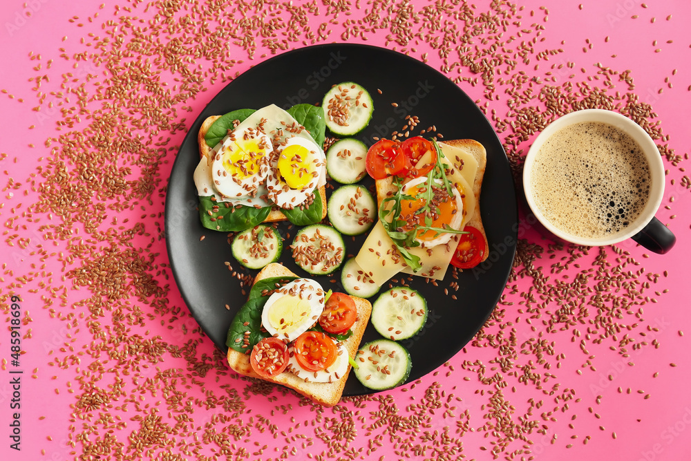 Plate with tasty toasts and cup of coffee on color background