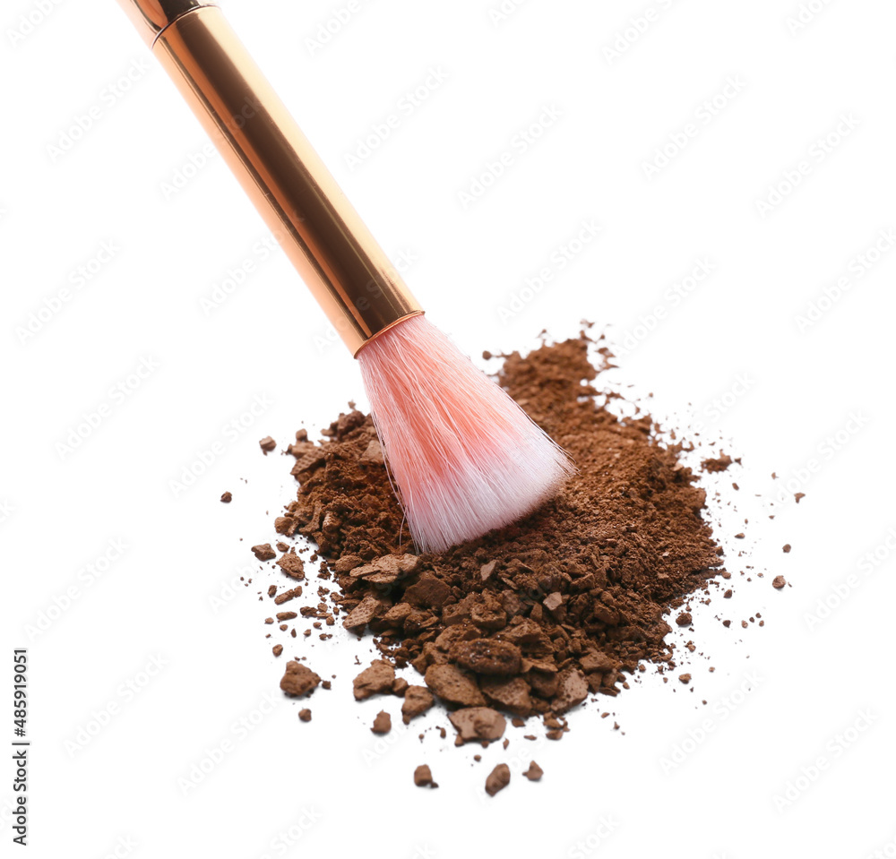 Makeup brush and loose eye shadow on white background