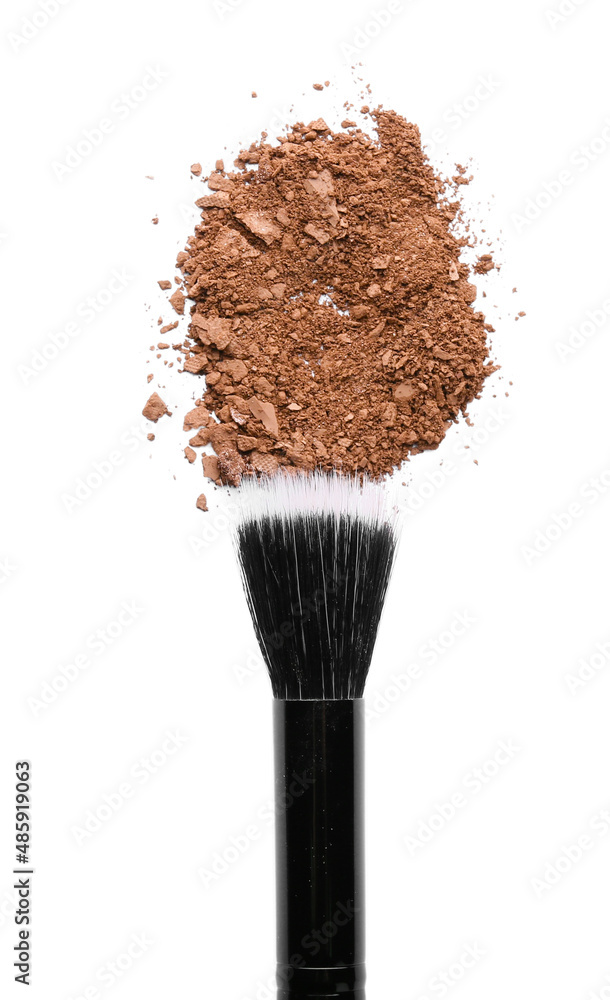 Makeup brush and loose eye shadow on white background