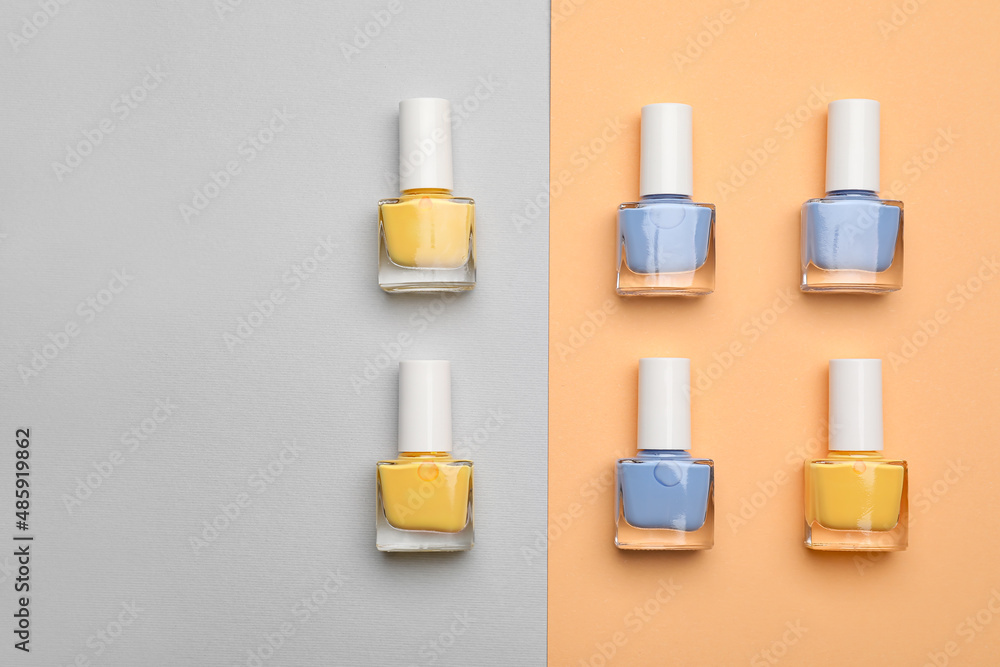 Set of nail polish bottles on color background