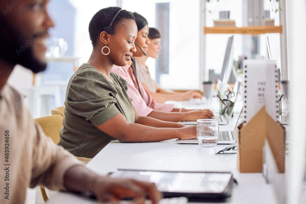 Were always happy to help. Shot of a businesswoman wearing a headset while working in a call centre.