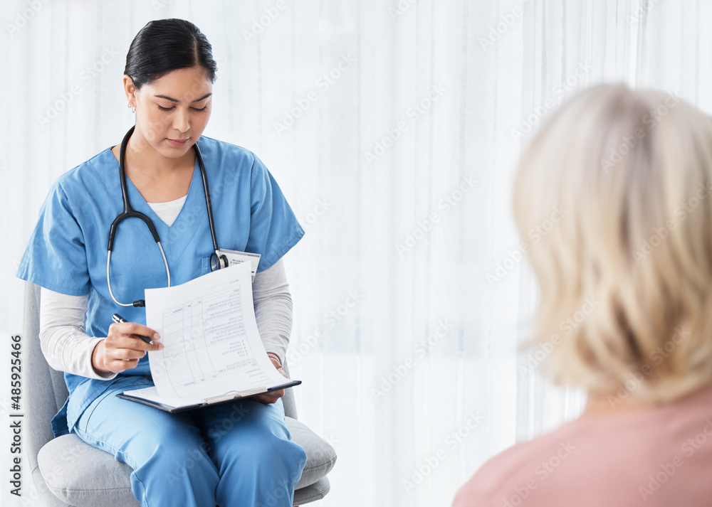 Looks like youre good to go home. Shot of a female nurse sitting with a clipboard while having a con