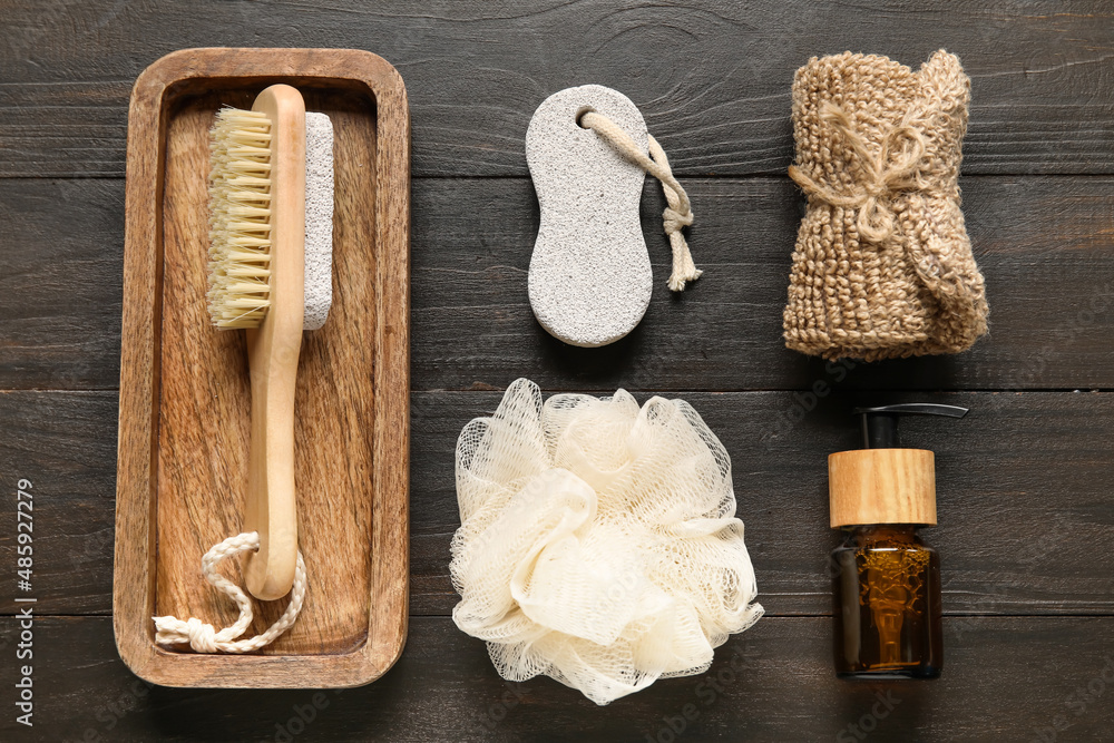 Set of bath supplies with essential oil on wooden background