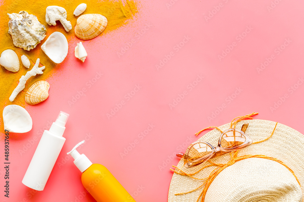 Skin care with sunscreen. Sun lotion and suglasses with straw hat