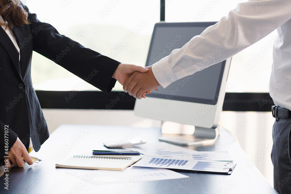 Businesspeople in the office handshake.