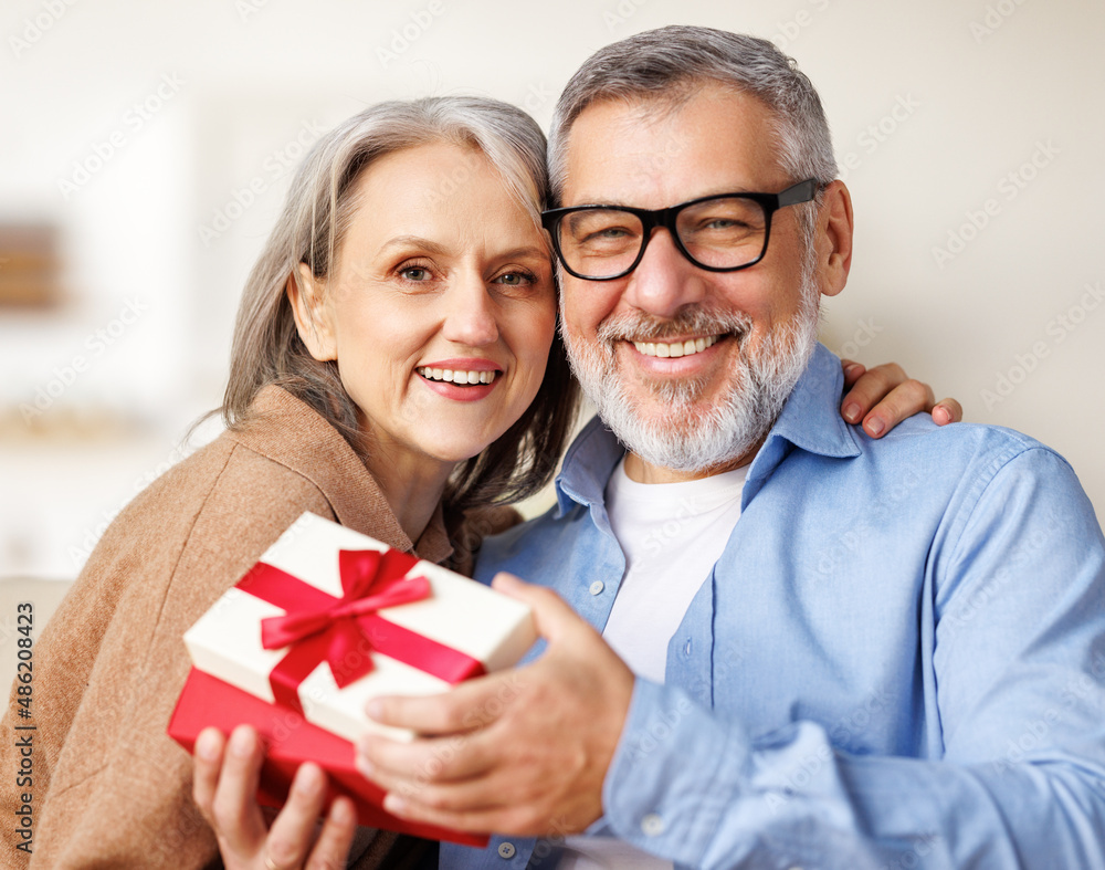 Happy romantic senior couple in love congratulating each other with Valentines Day at home