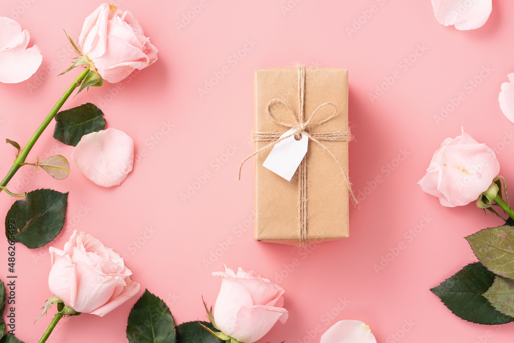 Valentines Day design concept background with pink rose flower and gift on pink background.