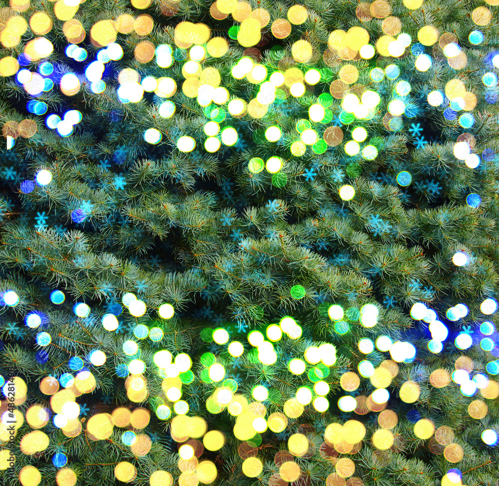 Closeup of Christmas tree with light and snowflakes