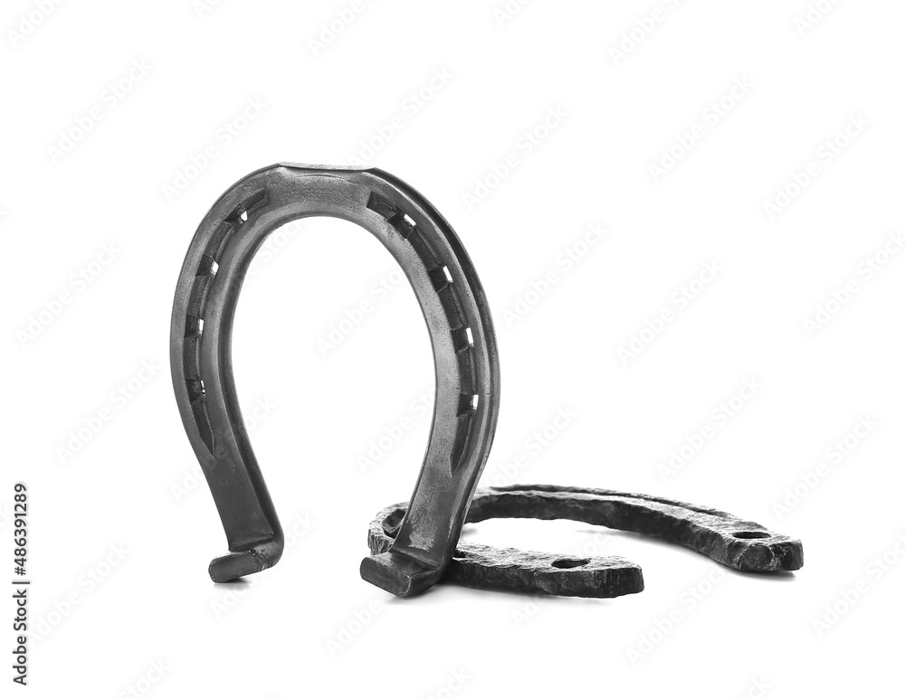 Iron horseshoes on white background