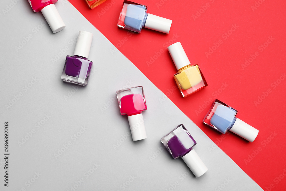 Set of nail polish bottles on color background