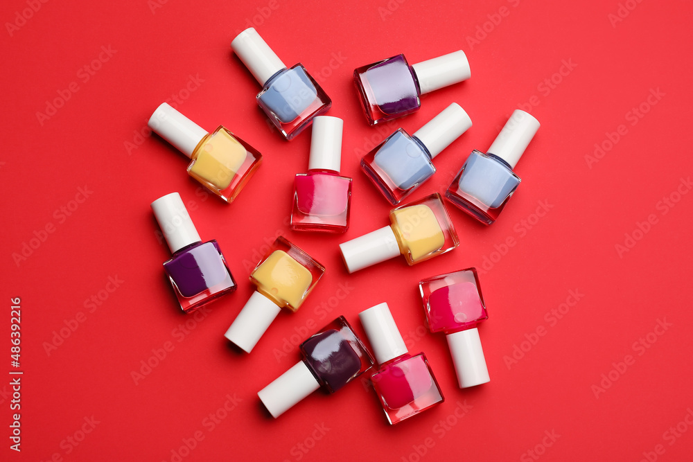 Set of nail polish bottles on color background