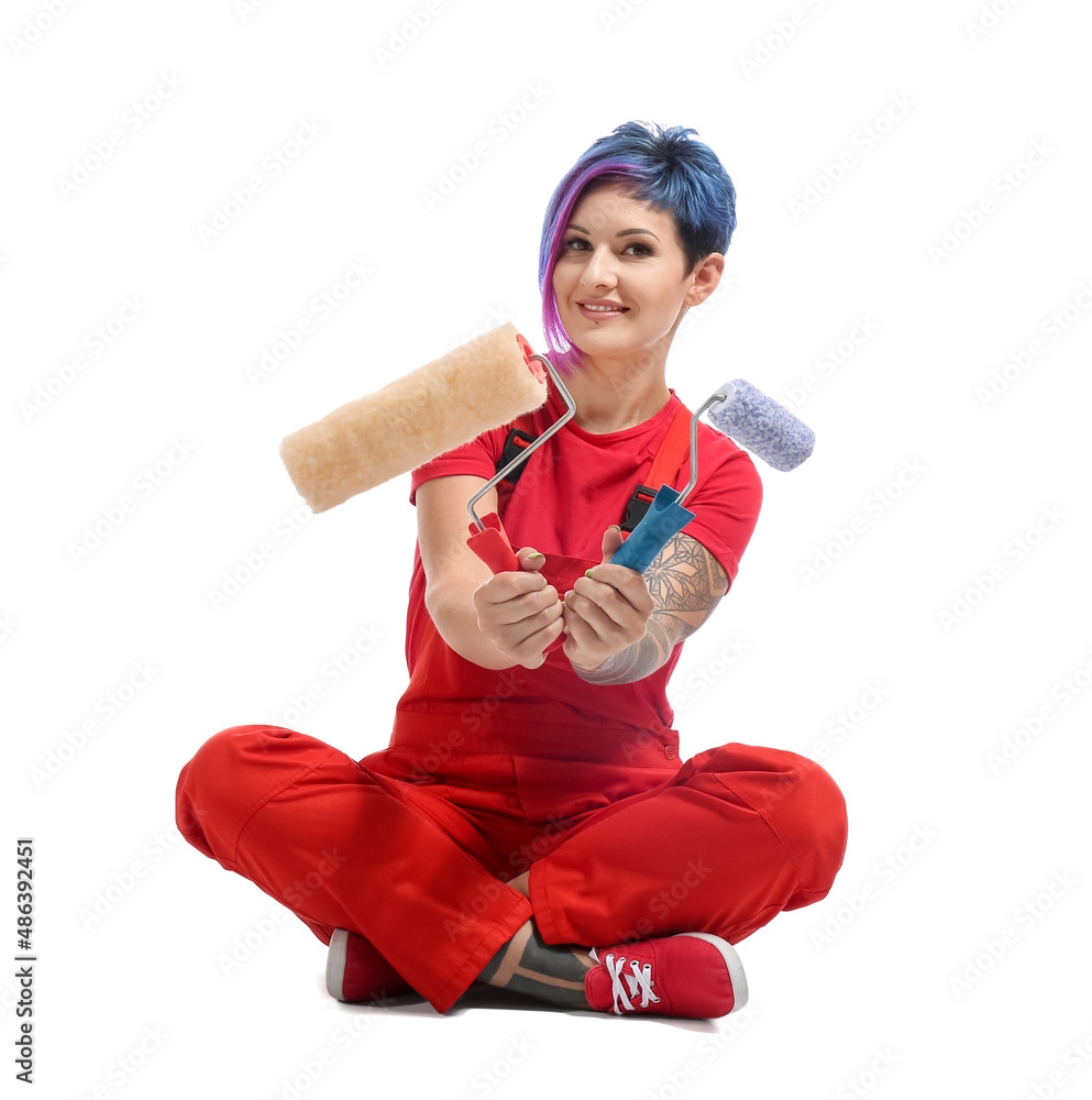 Female painter with rollers sitting on white background