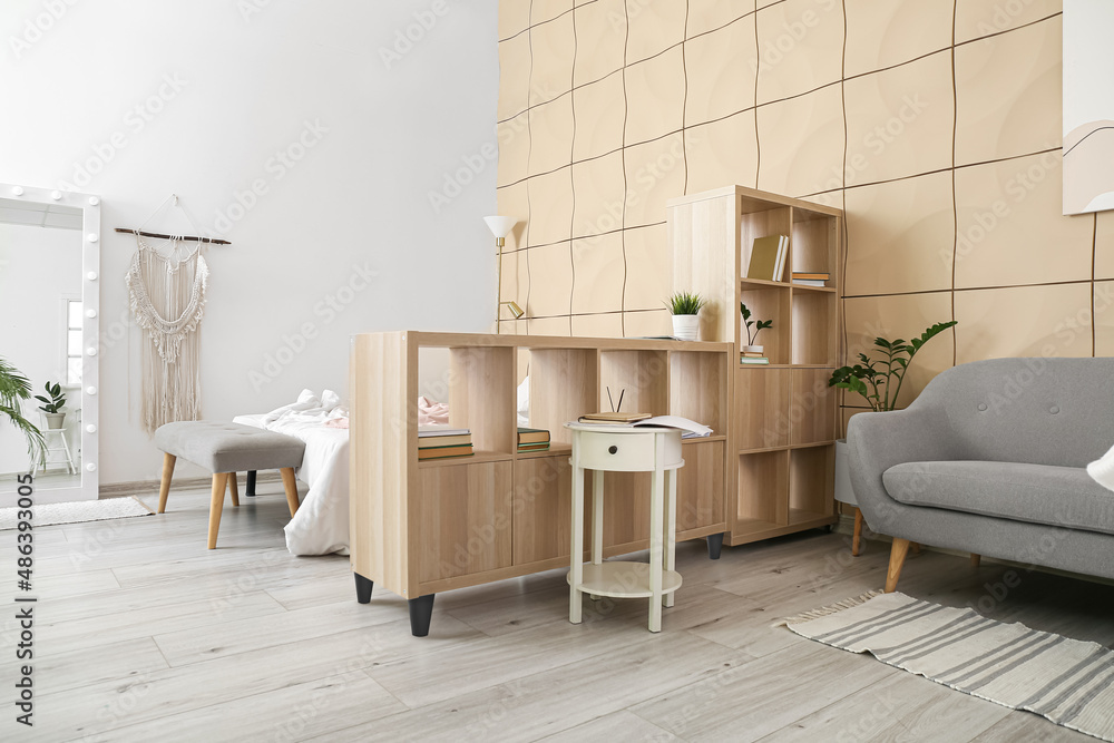 Wooden book shelf in interior of modern bedroom