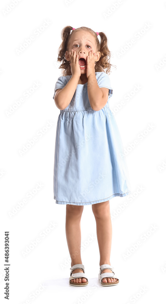 Shocked little girl in blue dress on white background