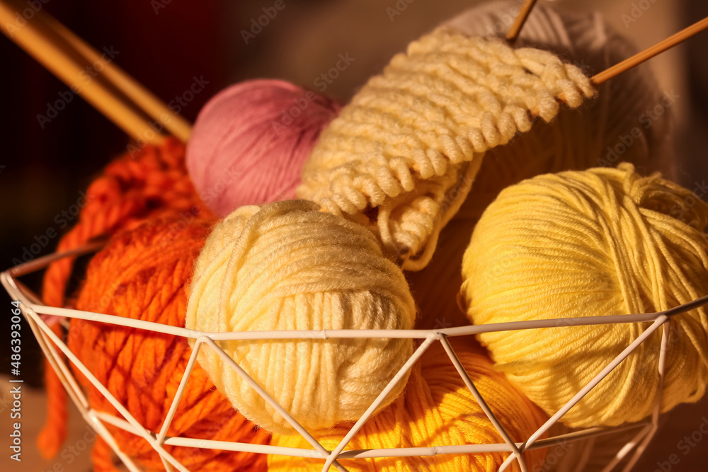 Basket with knitting yarn and needles, closeup