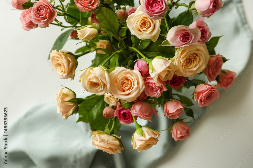 Bouquet of beautiful roses on table, closeup