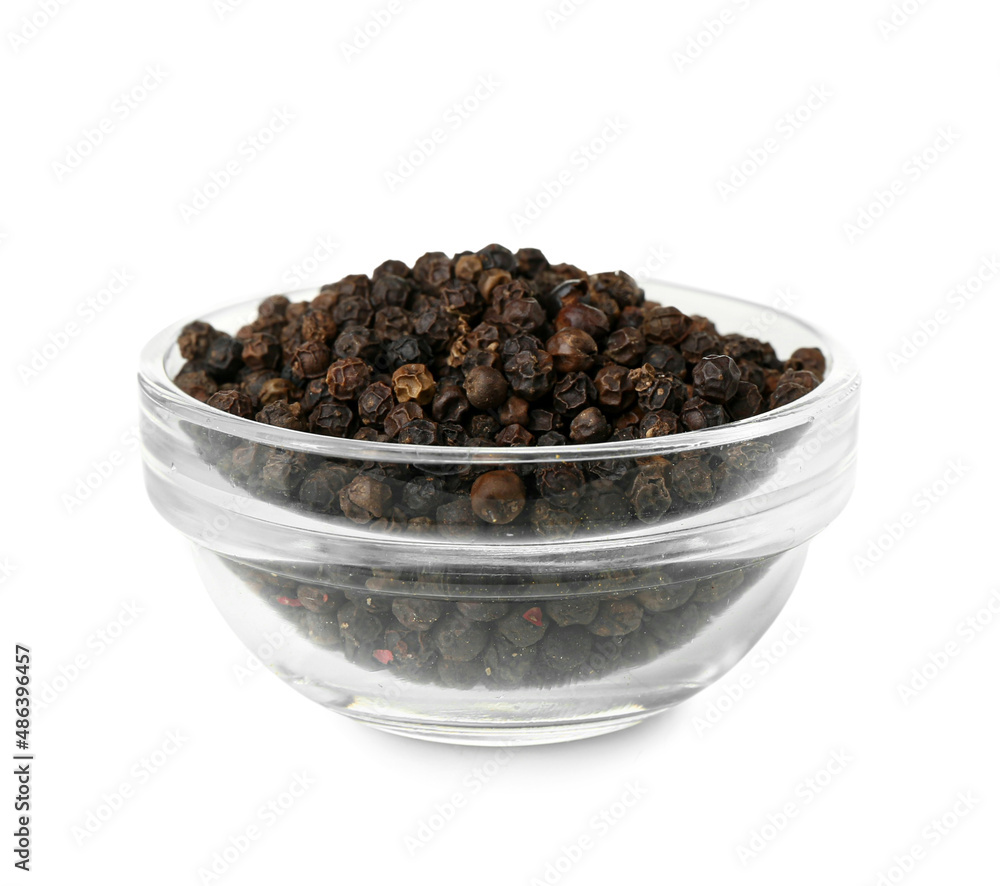 Bowl of black peppercorns on white background