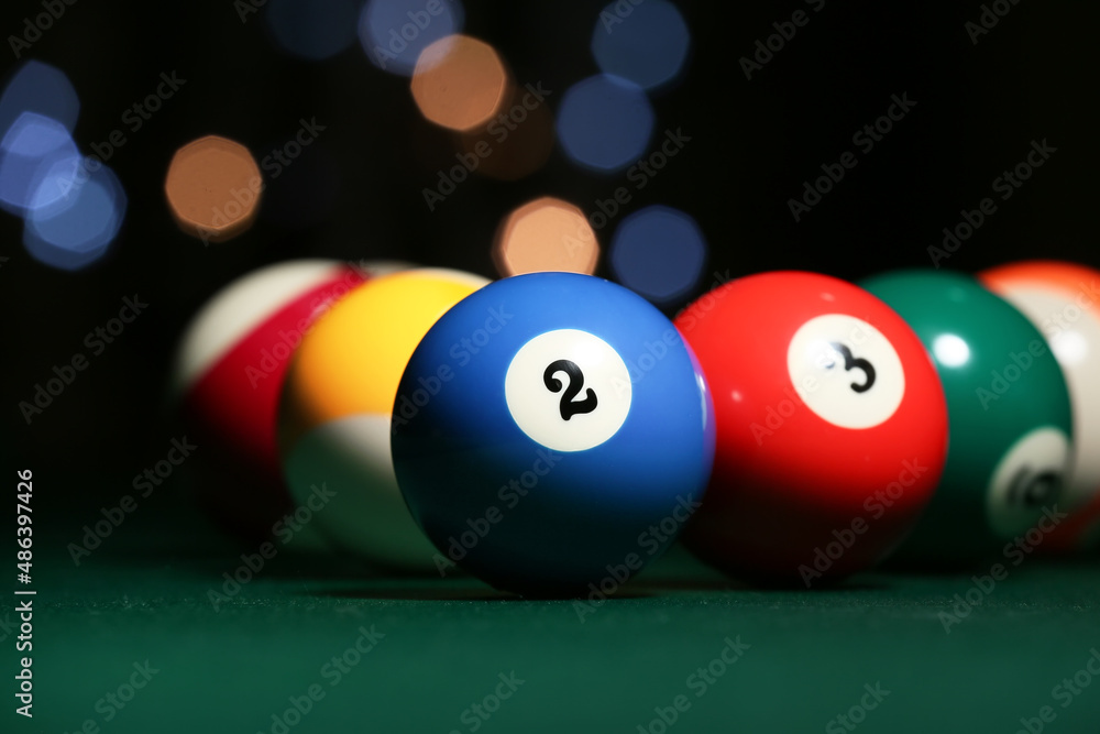 Different billiard balls on green table