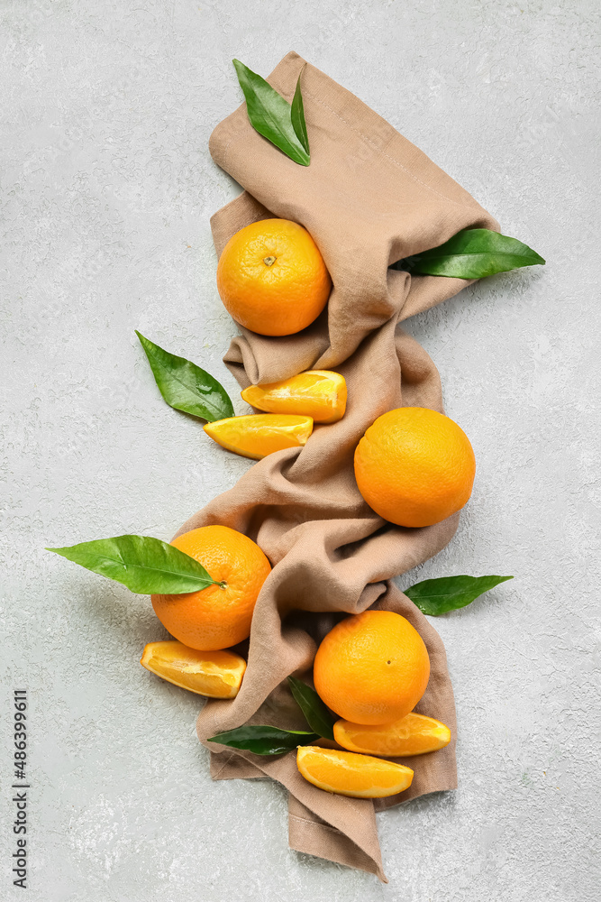 Fresh juicy oranges with leaves on white background