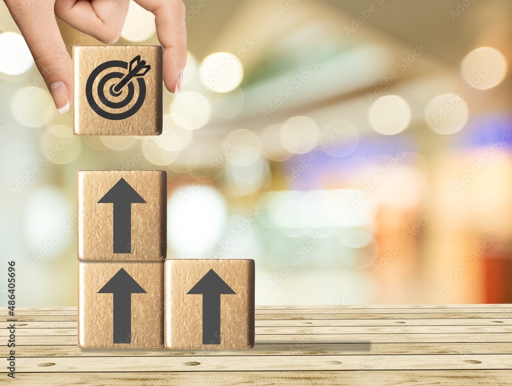 Businessman holding the wooden cube. Goals and planning for success in marketing business