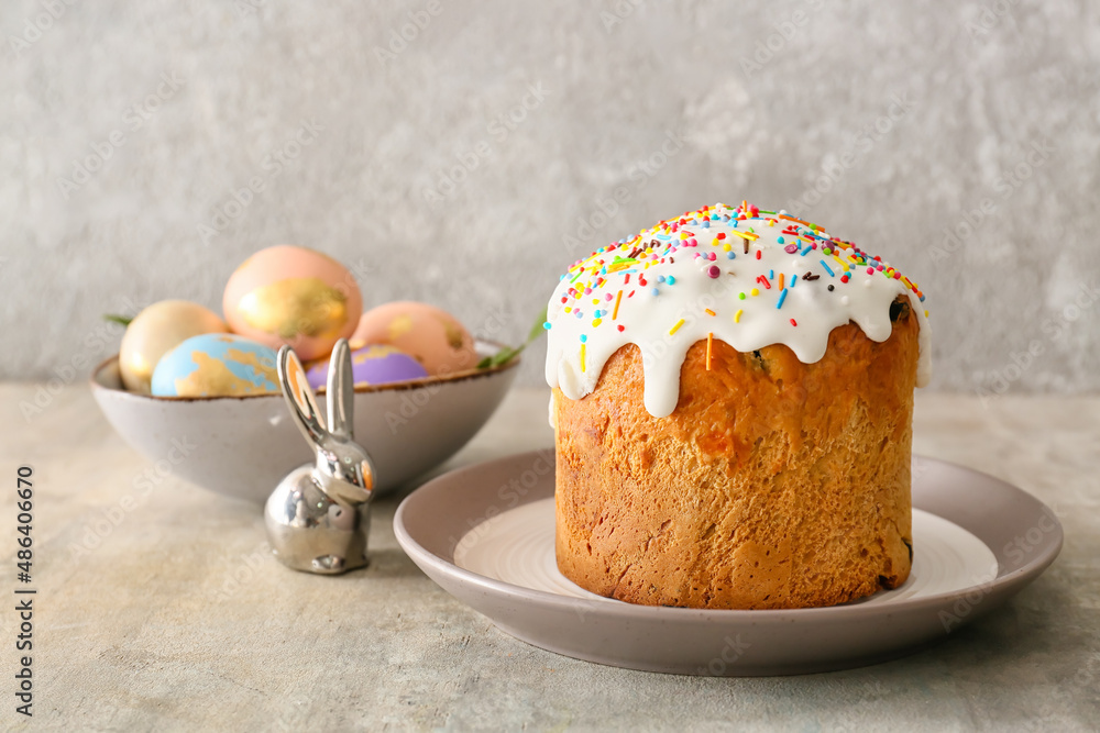 Plate with delicious Easter cake on grey background