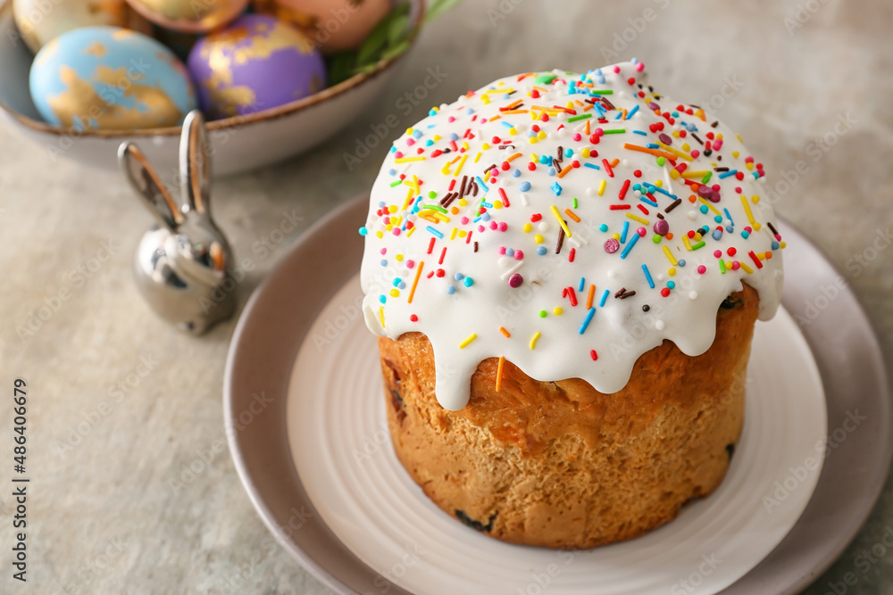 Plate with delicious Easter cake on grey background