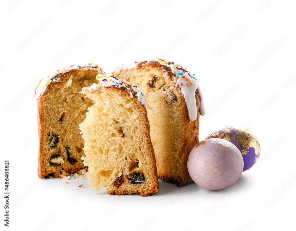 Cut Easter cake and eggs on white background