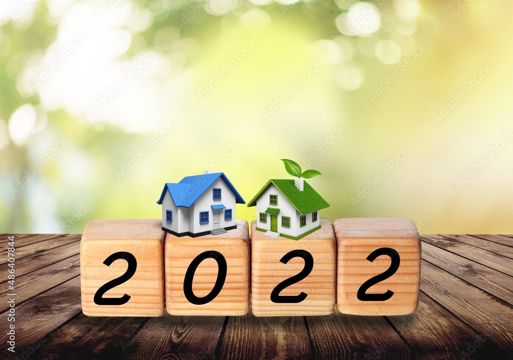 A house model and 2022 wooden blocks number. New year property investment concept.