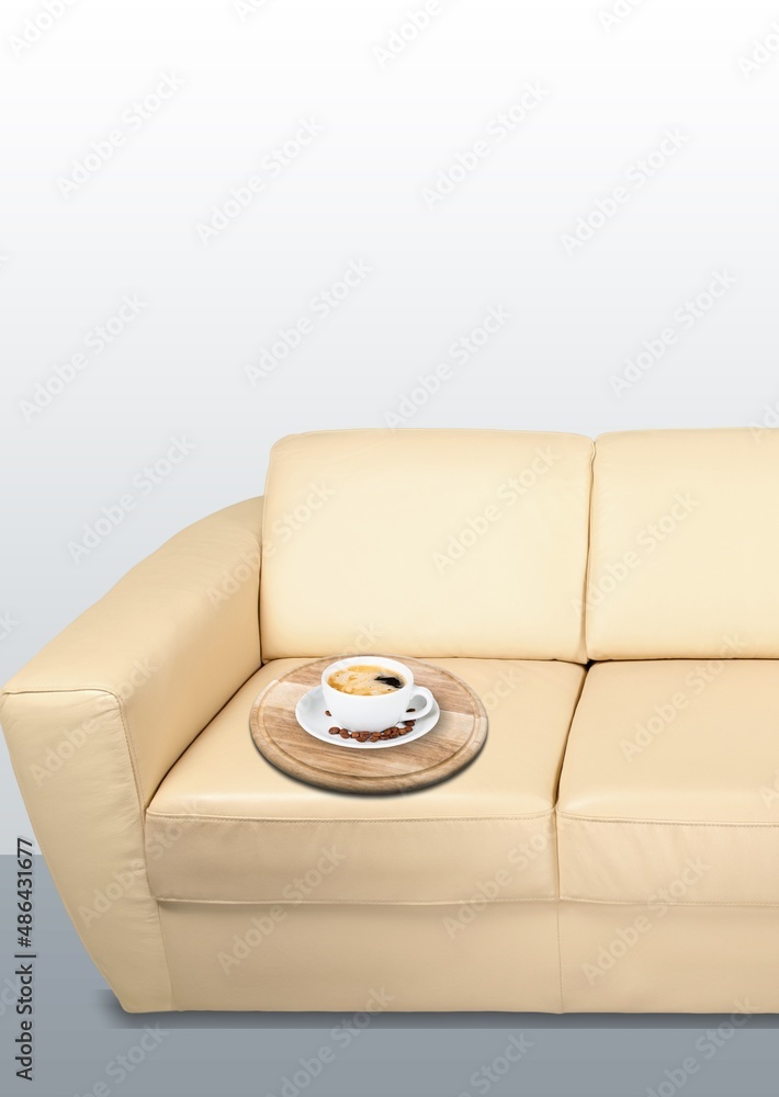 Beautiful interior. Sofa with cup of coffee in modern Scandinavian style room interior.