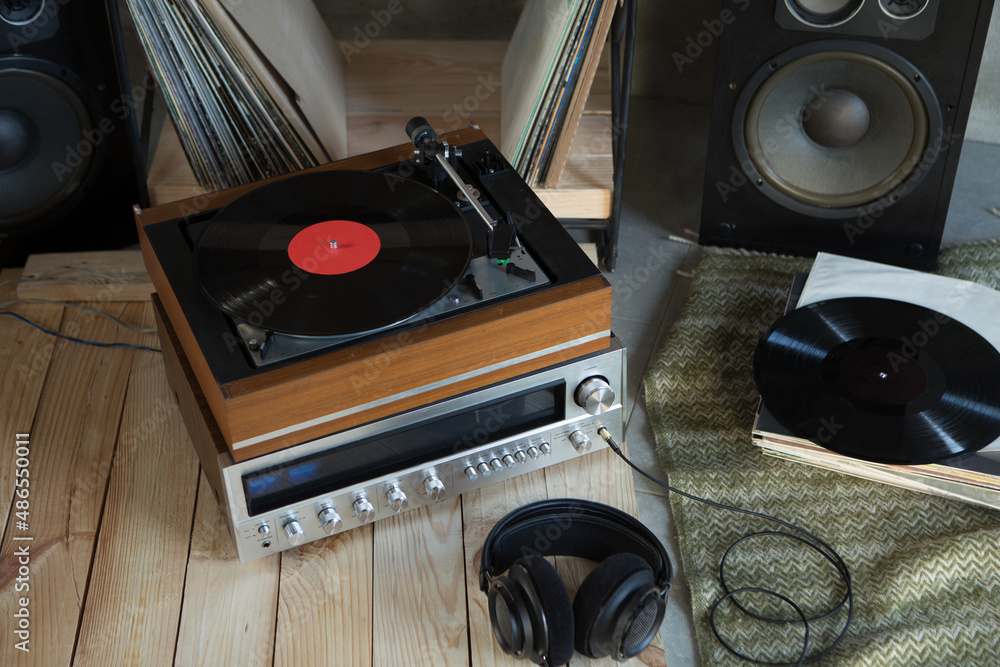 HiFi system with turntable, amplifier, headphones and lp vinyl records in a listening room