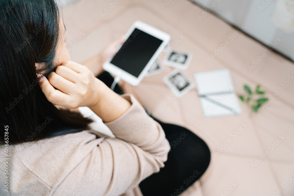 A pregnancy and music. belly of pregnant woman and headphones in the room