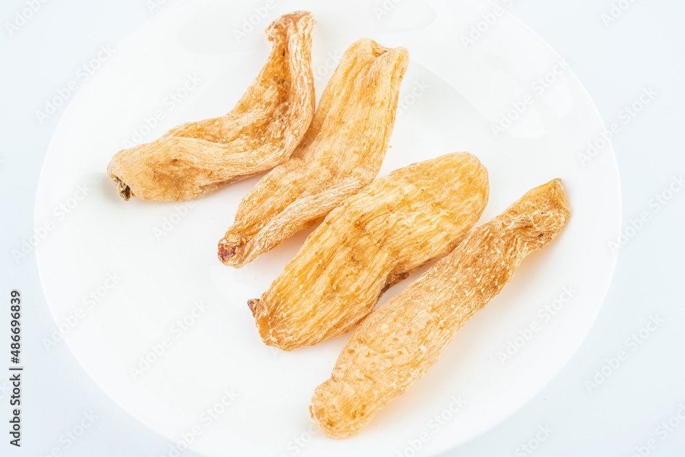 Dried Chinese herbal medicine Gastrodia elata on white background