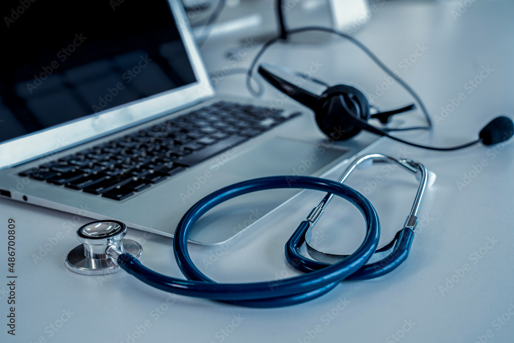 Headset and doctor equipment at clinic ready for actively support for patient by online video call .