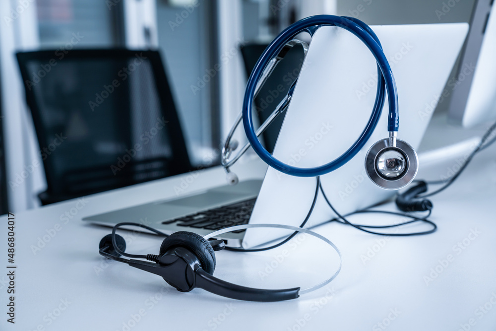 Headset and doctor equipment at clinic ready for actively support for patient by online video call .