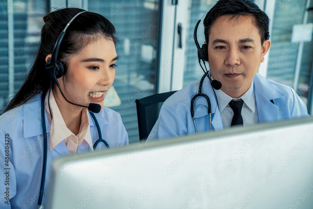 Doctor team wearing headset talking actively on video call in hospital clinic . Concept of telehealt