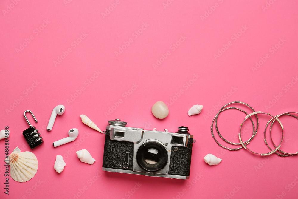 Composition with photo camera, earphones, female accessories and seashells on color background