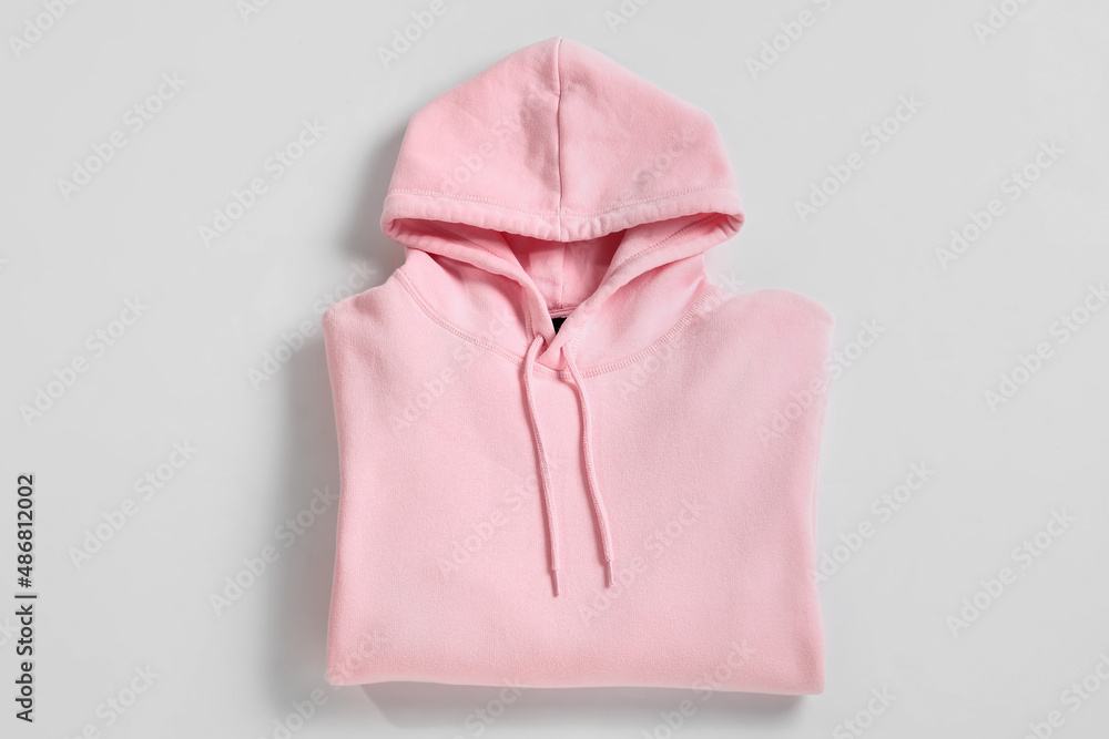 Stylish pink hoodie on white background