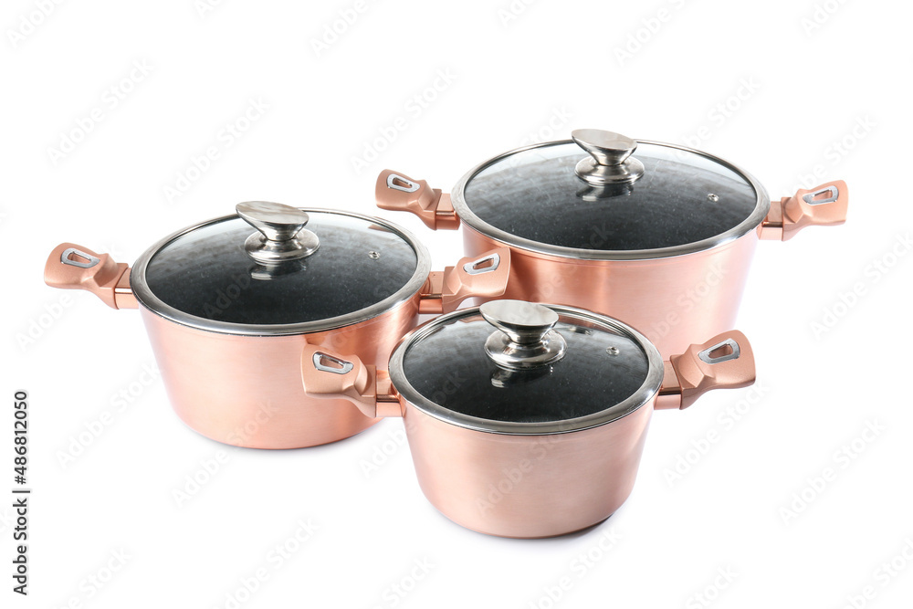 Set of copper cooking pots on white background