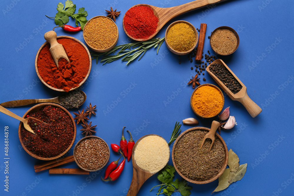 Frame made of aromatic spices on blue background