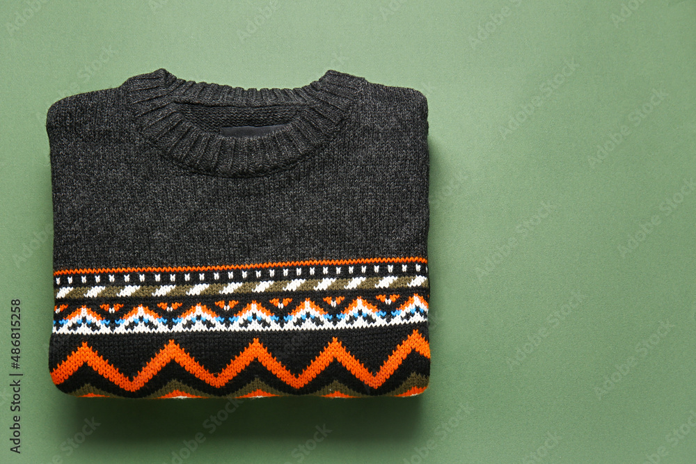 Dark sweater with stylish pattern on green background