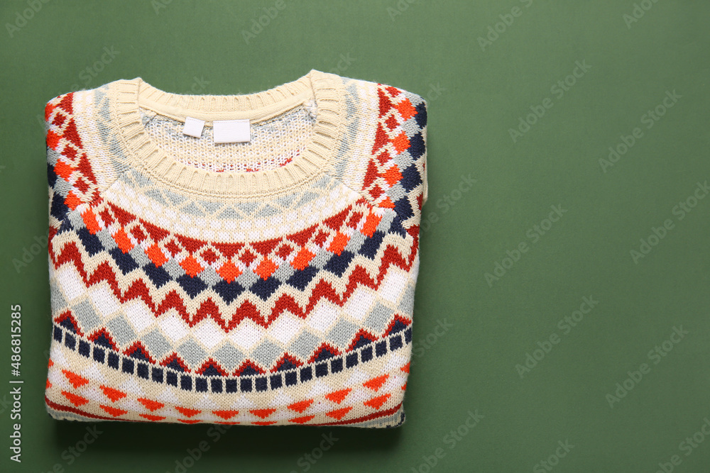 Warm sweater with stylish pattern on green background